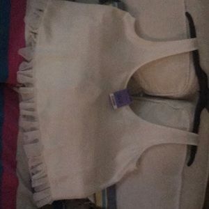 cream colored tank.With a ruffle